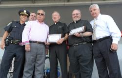 Father Richard Conway and Father Jack Ahern accepted their award as “Crime Fighters of the Year” during National Night Out events at Moakley Park in South Boston last week. Pictured are BPD Deputy Superintendent Nora Baston, Commissioner Ed Davis, Mayor Menino, Fr. Conway, Fr. Ahern and Suffolk County District Attorney Dan Conley. Photo by Isabel Leon/Mayor’s Office